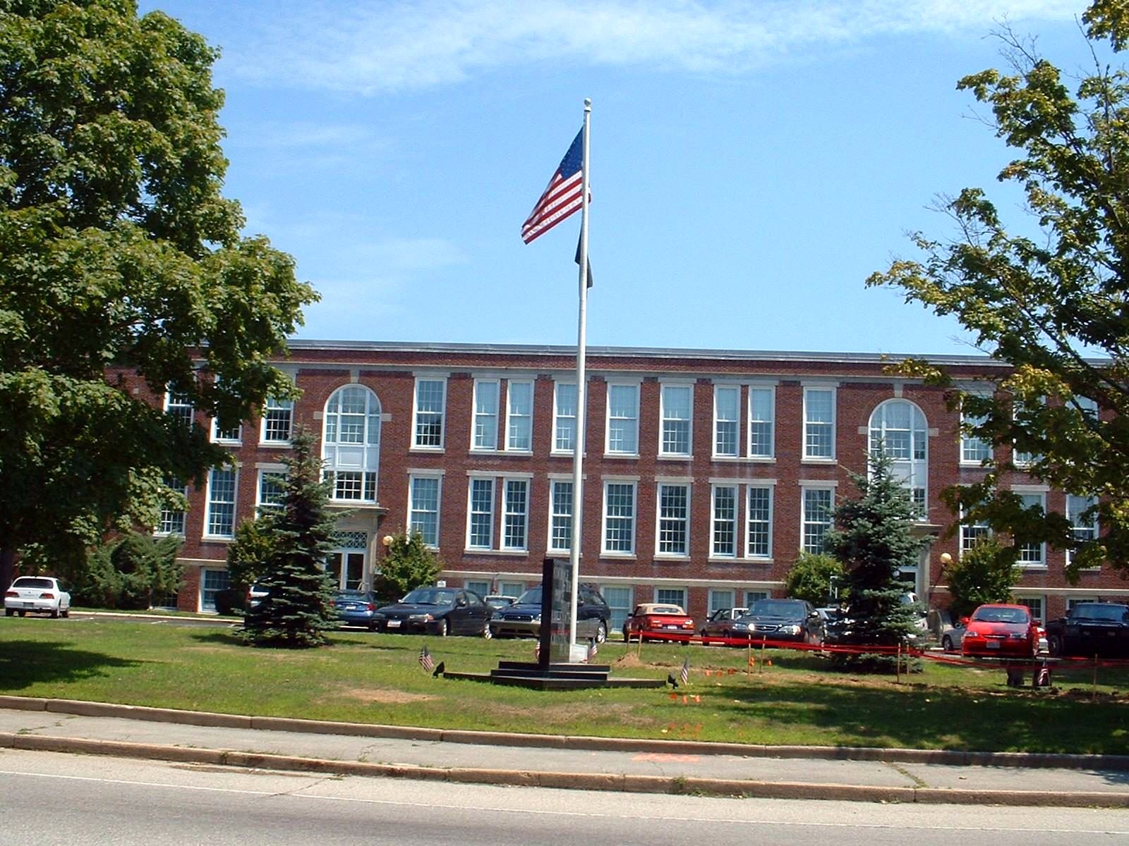 Dartmouth Town Hall, a brick building with a flagpole on the lawn.